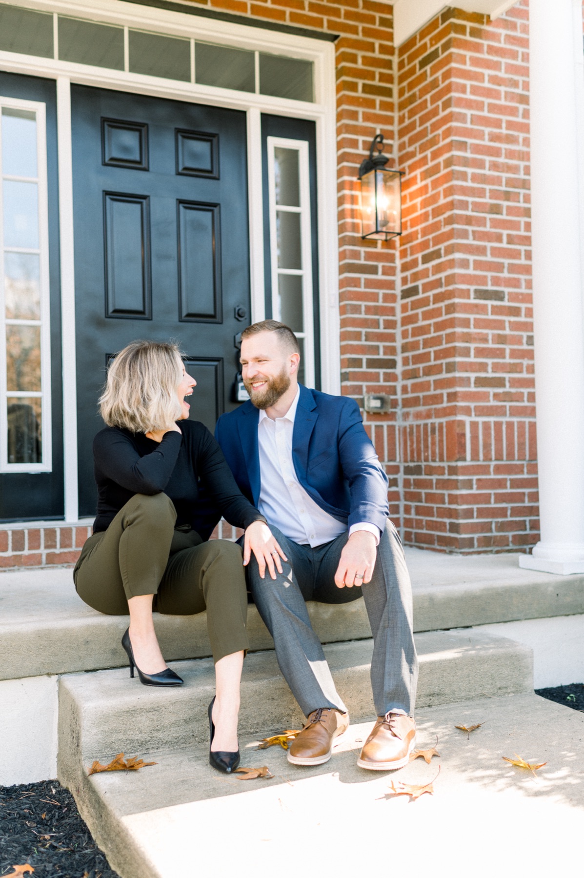 Ariella and Lukasz Boczniewicz on a home's front porch