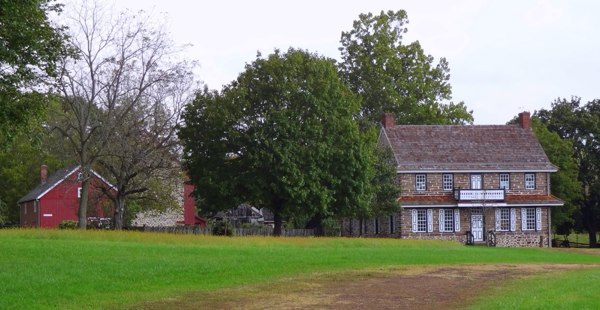 The Peter Wentz Farmstead's stone house and barn in open farmland, Worcester Township, Montgomery County PA
